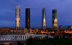 Frontal view of the four towers of Madrid at dusk