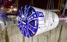Front view of the tunnel boring machine used for the creation of the tunnel while it is being lowered into the tunnel